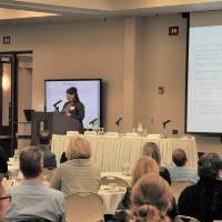 Amber Daniels from State of Michigan presenting to large audience